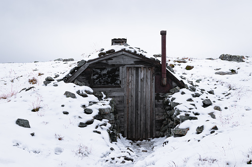 wooden house for tourists on top of a mountain in winter in Finnish Lapland