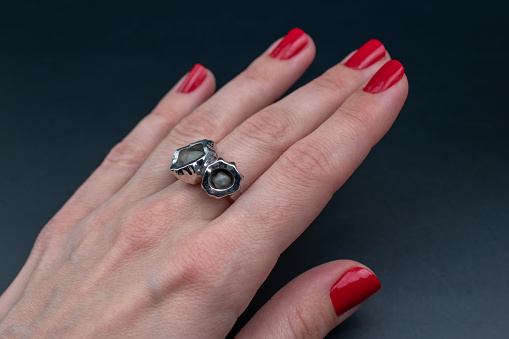 A captivating vintage ring adorns a woman's hand in this alluring promotional photo, embodying the essence of old-world elegance. Perfect for an online jewelry store's exquisite collection.