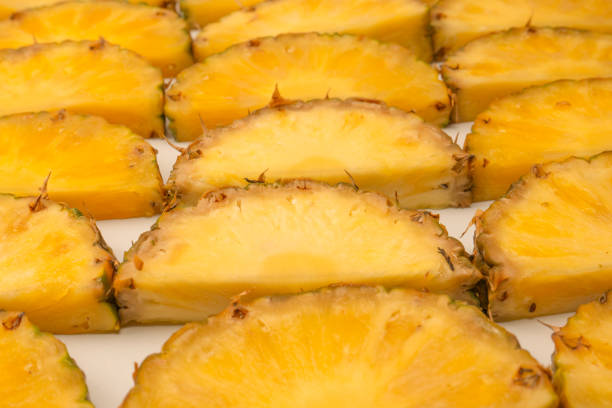 Pineapple juicy yellow slices on a white background. Top view.