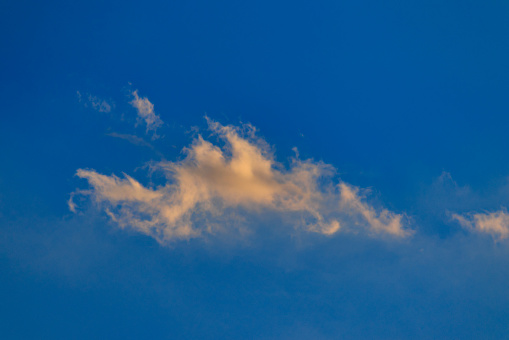 Orange shaded cloud, scattered by winds under a blue sky - POA,  SAO PAULO,  BRAZIL.