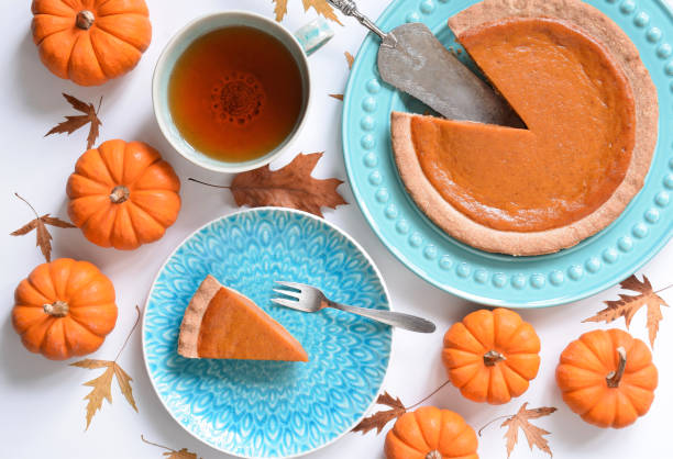 istock Top view of pumpkin pie on plate surrounded by mini pumpkins 1717162033