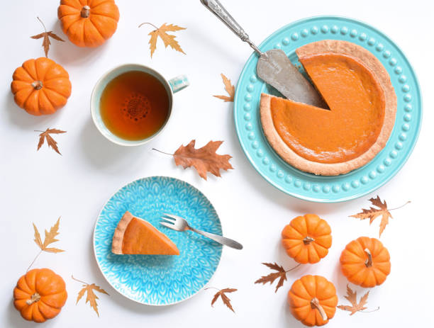istock Top view of pumpkin pie on plate surrounded by mini pumpkins 1717162049