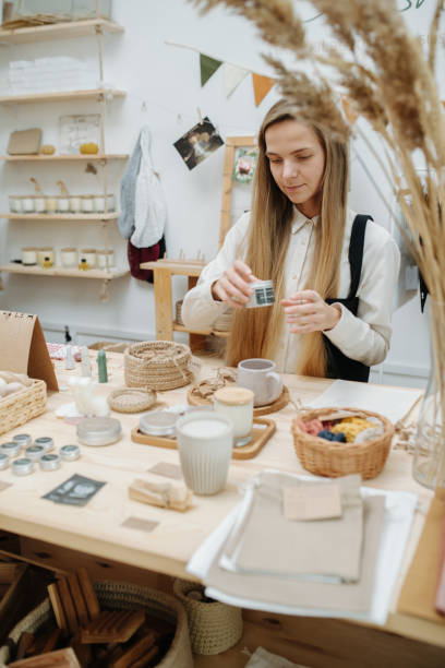 Girl in an eco goods store chooses something for herself stock photo