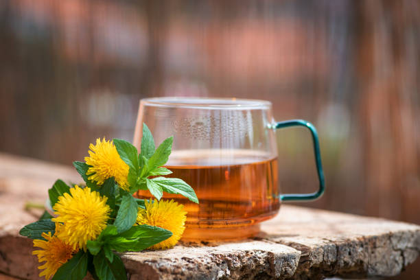 Cup of tea with dandelion flower