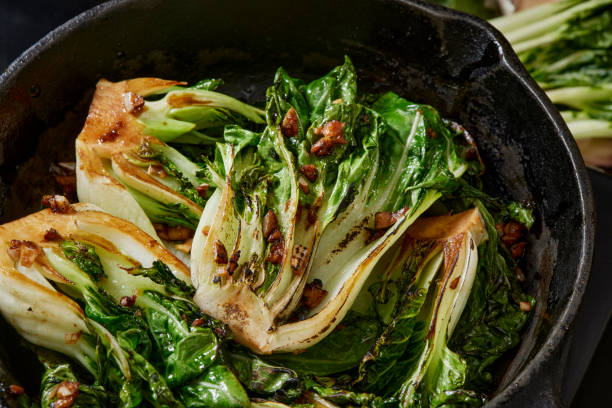 knoblauch und soja gerösteter baby pak choi - chinesischer senfkohl stock-fotos und bilder