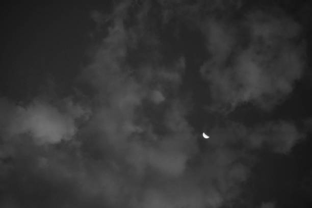Distant crescent moon, beneath a sheet of clouds covering the night sky - POA,  SAO PAULO,  BRAZIL.