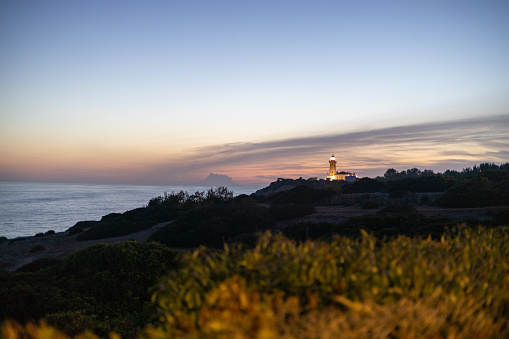 South coast of Portugal. Lighthouse at dusk.
