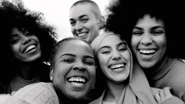istock Happy group of multiracial women having fun outdoors - Real people from different ethnicity celebrating outdoors - Lifestyle and youth culture concept - Black and white editing 1717226474
