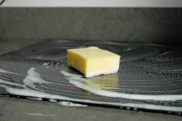 istock cleaning electric stove with sponge 1717237259