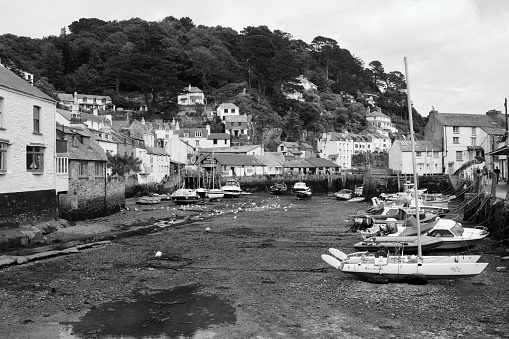 Black and white image of the picturesque harbour of Polperro with its ancient smuggling heritage is still a busy fishing harbour today and a tourist hot spot.