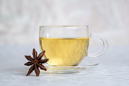 white mug with tea on a white isolated background. front view