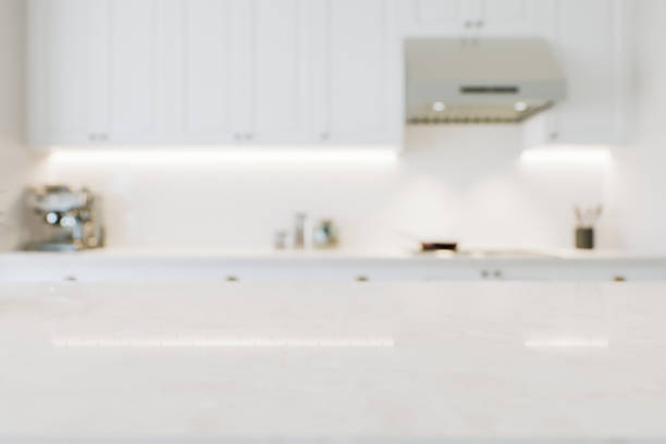istock Macro focus on kitchen countertop for product presentation and advertising. White kitchen with marble surface and blurred background. 3D visualization 1717263269