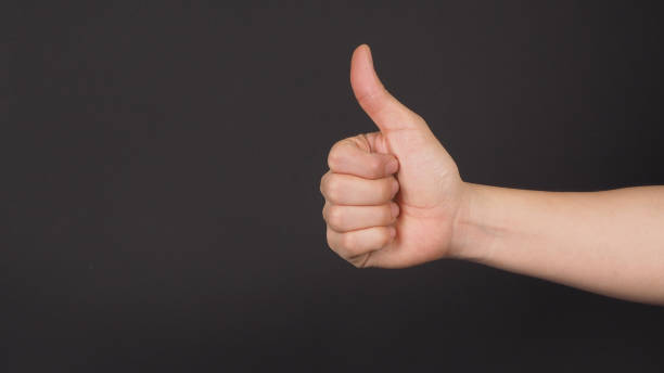 istock The thumbs up or like hand sign on black background. 1717273887