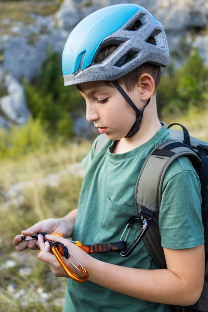 istock Young boy hiking in the mountains. He is using hiking equipment and wearing a backpack. He is texting, sending video messages or taking selfie. Vlogger enjoying his job. 1717275380