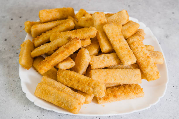 istock Crunchy breaded fish sticks made from wild caught Alaskan Pollock close-up on white plate 1717282645