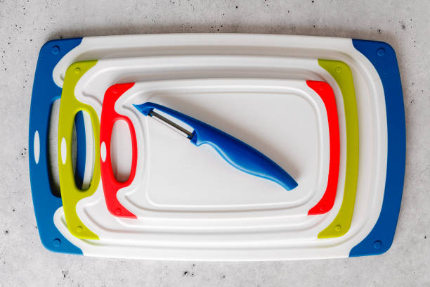 istock Plastic cutting boards in different colors and sizes, and vegetable peeler close-up 1717282648