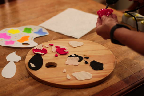istock Woman Applying Hot Glue to Felt 1717285067