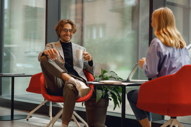 istock Two diverse business colleagues working together on project sitting in modern coworking 1717295885