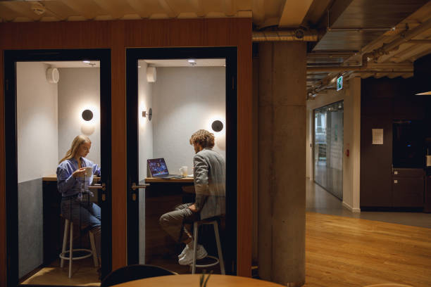 istock Two diverse business people working in modern coworking space 1717311076