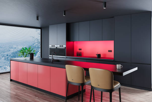 istock Black Modern minimalist kitchen with long island with stools. Dark materials. Red details. 1717317731