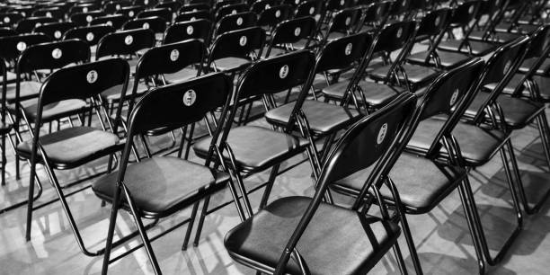 istock rows of black empty chairs in entertainment hall 1717318301