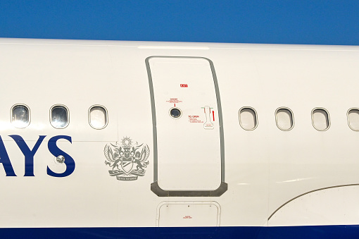 Luqa, Malta, UK - 7 August 2023: Close up view of the emergency exit on an Airbus A321 jet operated by British Airways