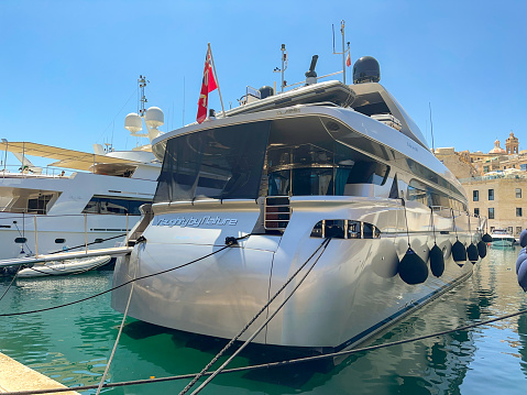 Valletta, Malta - 3 August 2023: Luxury super yacht Naughty by Nature moored in the harbour in Three Cities in the island's capital, Valletta