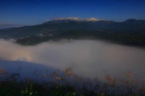 Scenic view of fog covering mountains in Laos at sunrise