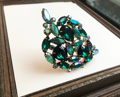 Hands showing diamond. Emerald.