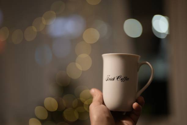 istock hand holding cup , Man holding a white cup of hot beverage 1717390688