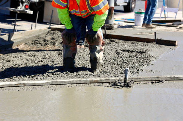 istock Road construction crew pouring concrete for the new sidewalk 1717401776