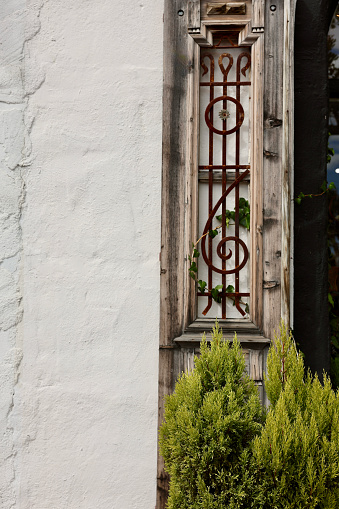 Vintage weathered shutter with rusty metalwork inlay