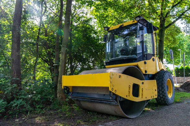 istock Yellow road roller on the background of forest and lawn. 1717430232