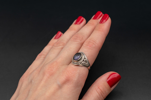 A stunning vintage-inspired ring adorned with vibrant gemstone crystals, showcasing the timeless beauty of colorful gems in a captivating promotional photo.