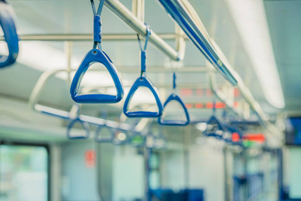 istock Abstract blurred background of subway train interior, blue handles for passengers, public transportation 1717445598