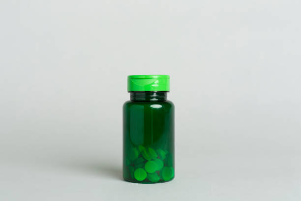 Plastic bottle for vitamins on color background