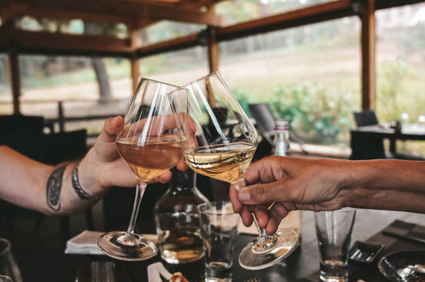 istock People toasting wine glasses in a restaurant. 1717455380