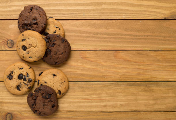 istock Flat lay with chocolate chip cookies on wooden background 1717465621