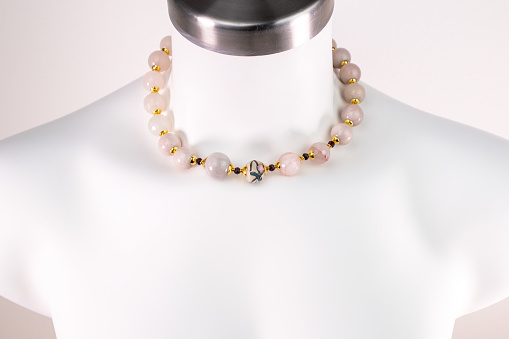 A stunning vintage-inspired necklace for women elegantly showcased on a white mannequin, exuding timeless charm and allure. This promotional photo captures the essence of a unique jewelry piece, perfect for an online jewelry store.