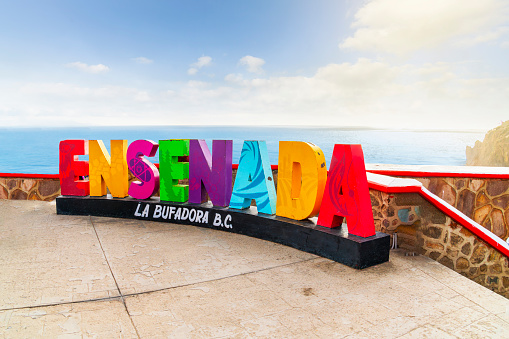 General view of the colorful Ensenada sign at the oceanfront La Bufadora blowhole, on the Punta Banda peninsula of Ensenada, Mexico.