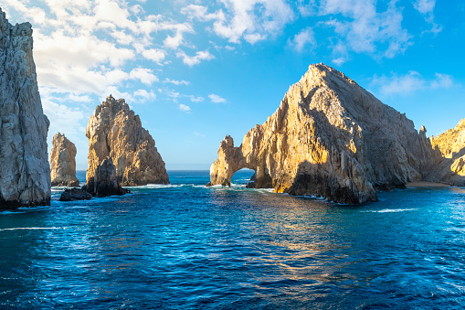 The El Arco Arch at the Land's End rock formations on the Baja Peninsula, at Cabo San Lucas, Mexico.  The arch of Cabo San Lucas is a distinctive granitic rock formation at the southern tip of Cabo San Lucas, which is itself the extreme southern end of Mexico's Baja California Peninsula. The arch is locally known as \