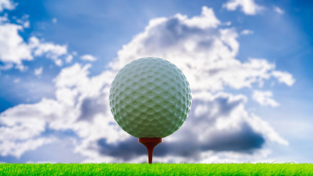 istock Golf ball on stand in short grass area, against light with blue sky with clouds, 3d illustration 1717571030