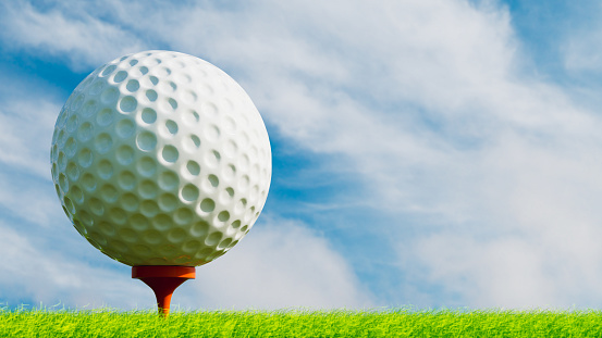 Golf ball on orange stand on short grass ground with blue sky with clouds, 3d illustration, horizontal image