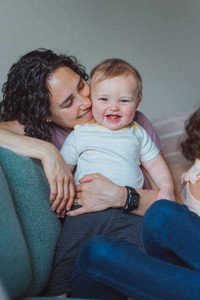 istock Loving mom snuggling happy baby 1717574430