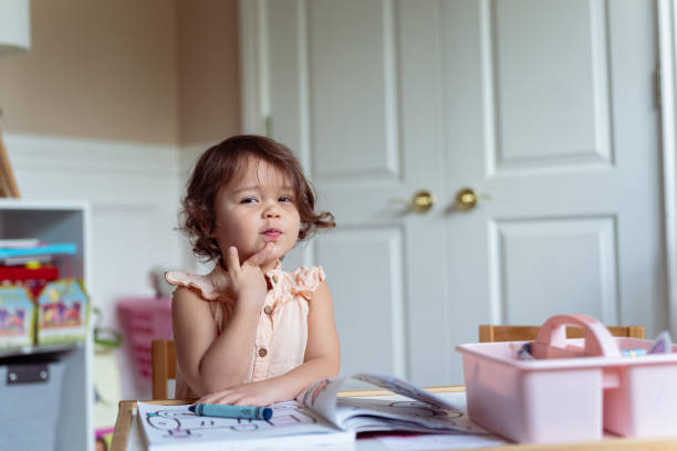 Little girl thinking hard and having ideas while working on an art project