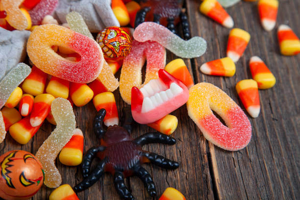 istock Mixed Halloween candy on wooden rustic background 1717582554
