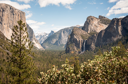 Scenic view from the iconic Tunnel View of Yosemite Valley with cloudy skies above, in Yosemite National Park