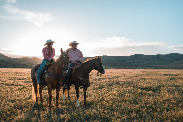 istock Husband and Wife Relaxing while Riding Horses Together 1717656114