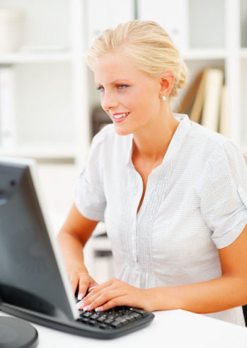 Portrait of happy young woman using computer