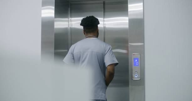 istock African American doctor presses lift call button 1717726518